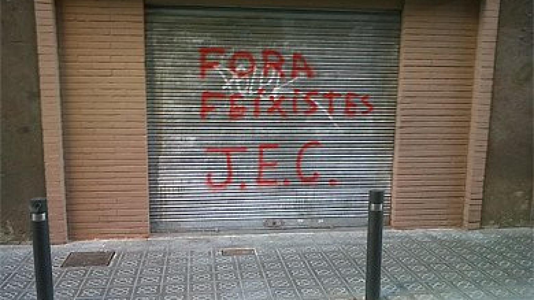 Sede del PP del barrio de Les Corts con una pintada insultante en la persiana