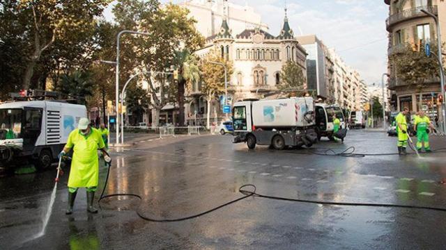 Operarios de la limpieza tratan de retirar los restos de cera de las velas tras la manifestación por la liberación de Jordi Sànchez (ANC) y Jordi Cuixart (Òmnium) / EFE