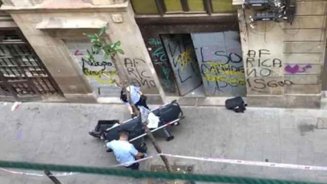 Dos trabajadores se preparan para levantar el cuerpo de la mujer muerta por sobredosis / ACCIO RAVAL