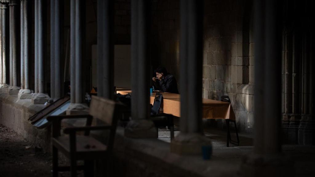 Una persona sin techo come en las instalaciones de la parroquia de Santa Anna, en Barcelona / EUROPA PRESS - David Zorrakino