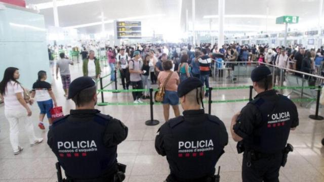 Tres agentes de Mossos d'Esquadra vigilando la zona tierra de El Prat