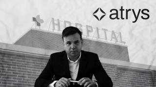 José Elías, presidente de Audax y primer accionista de Atrys Health, y el logo de la firma