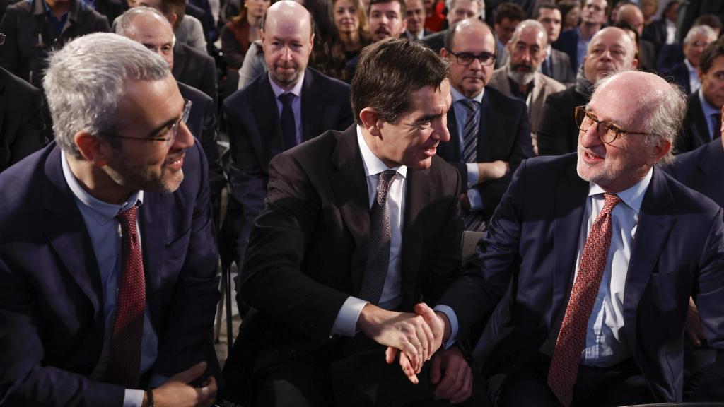 El presidente del Repsol, Antonio Brufau (d), saluda al presidente del BBVA, Carlos Torres Vila (c), en presencia del presidente de Aena, Maurici Lucena (i), mientras asisten a la presentación por parte del presidente catalán, Salvador Illa, de su plan para que Cataluña recupere el liderazgo económico de España mediante la movilización de 18.500 millones de euros hasta el año 2030, durante un acto celebrado este jueves en Madrid