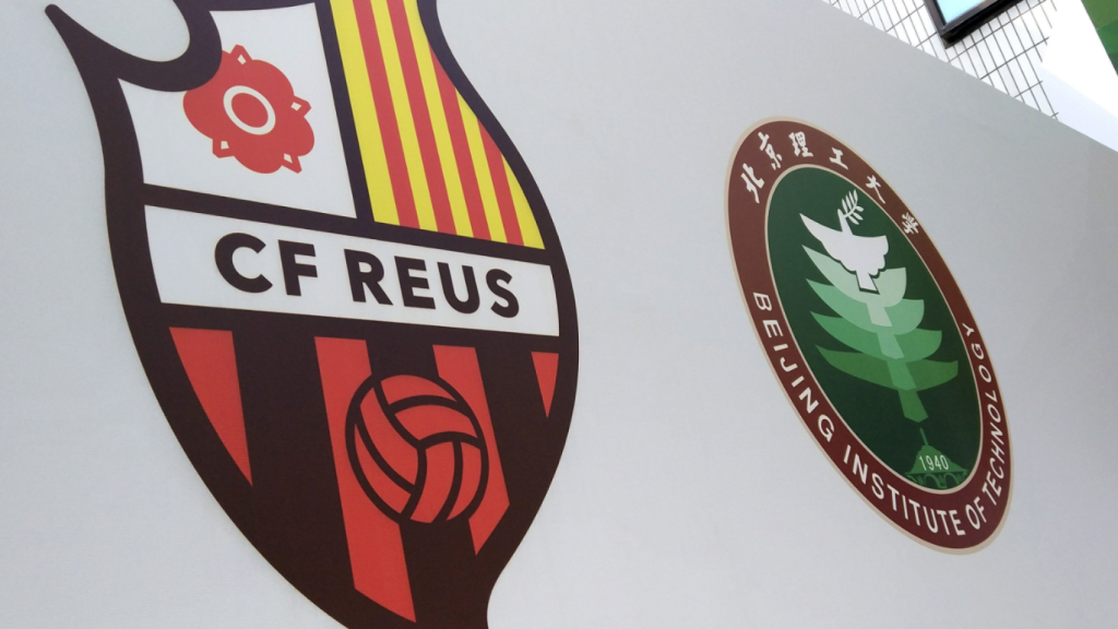 L'escut del CF Reus Deportiu, al costat del BIT FC