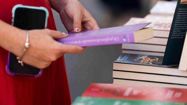 Una lectora coge entre sus manos un libro en el día Sant Jordi 2025, en una imagen de archivo