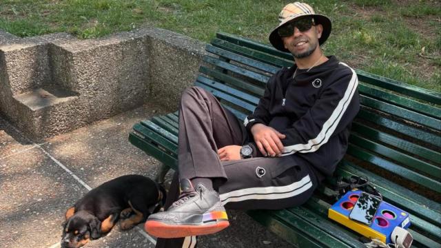 El padre de Lamine Yamal, sentado en un banco junto a un perro