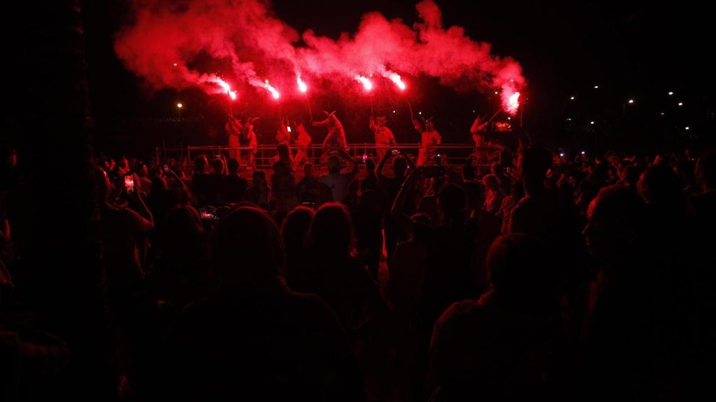 Varias personas vestidas de demonio lanzan bengalas durante la celebración de un ‘correfoc’