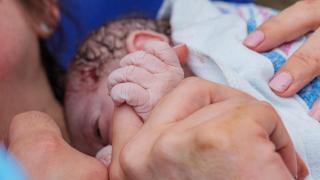 Una madre abraza a su bebé recién nacido