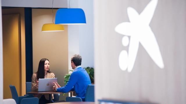 Una empleada de CaixaBank asesora a un cliente