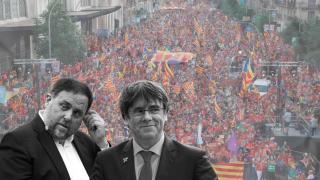 Oriol Junqueras y Carles Puigdemont, con una manifestación independentista de fondo