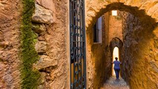 Una mujer pasea por la calle más estrecha de Cataluña, que está en Tarragona