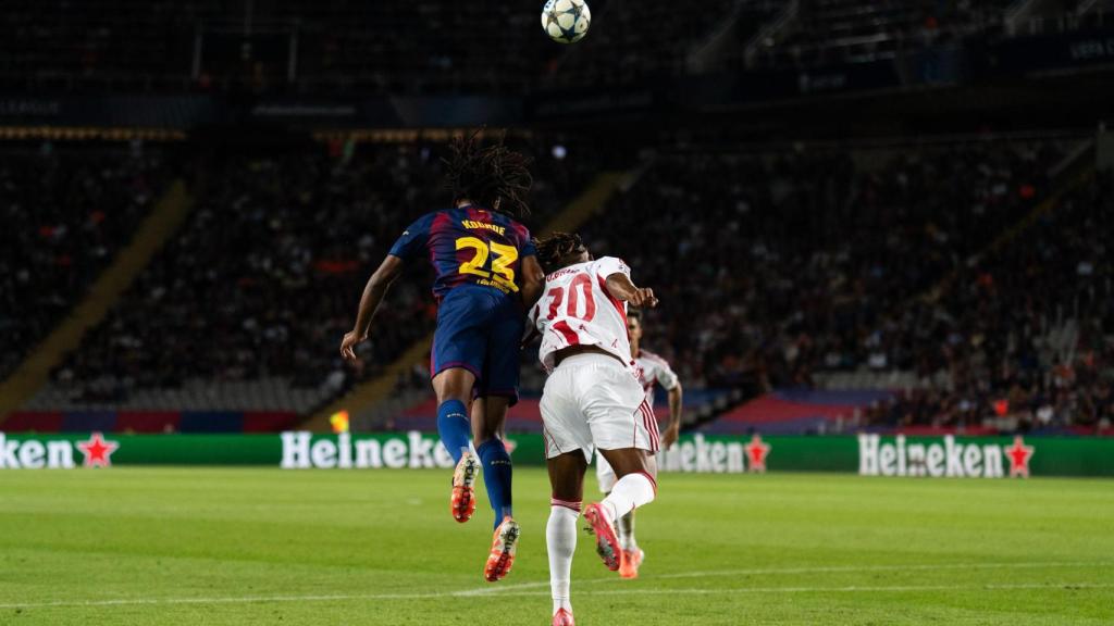 Jules Koundé disputa un balón aéreo durante el Barça-Olympiacos