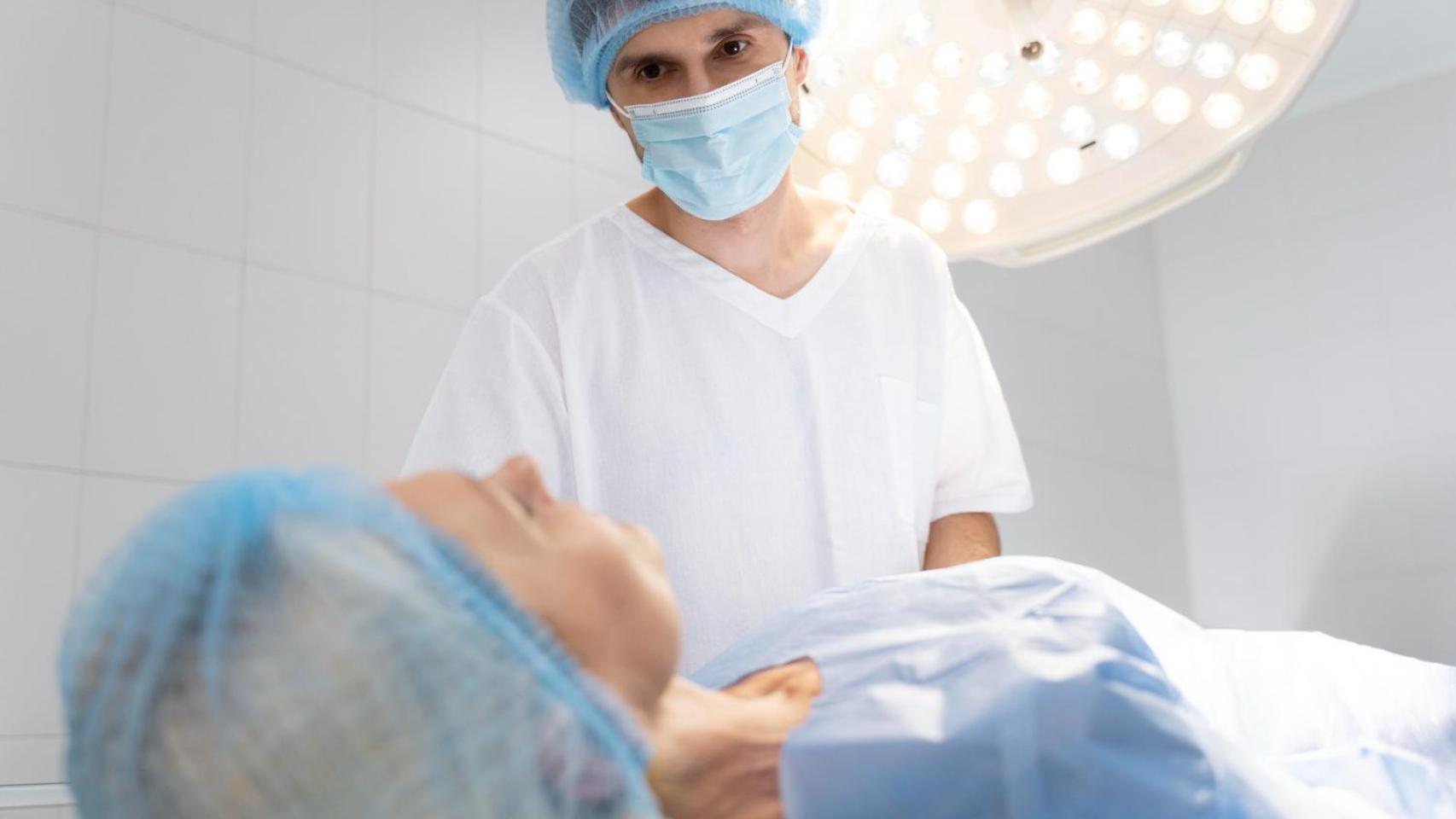 Paciente y cirujano plástico en un quirófano de hospital