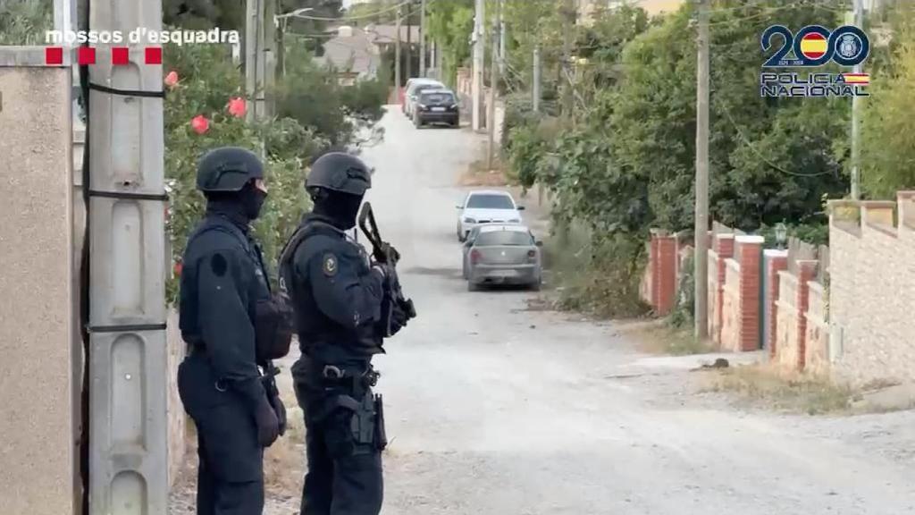 Agents dels Mossos d'Esquadra custodiant un dels habitatges escorcollats