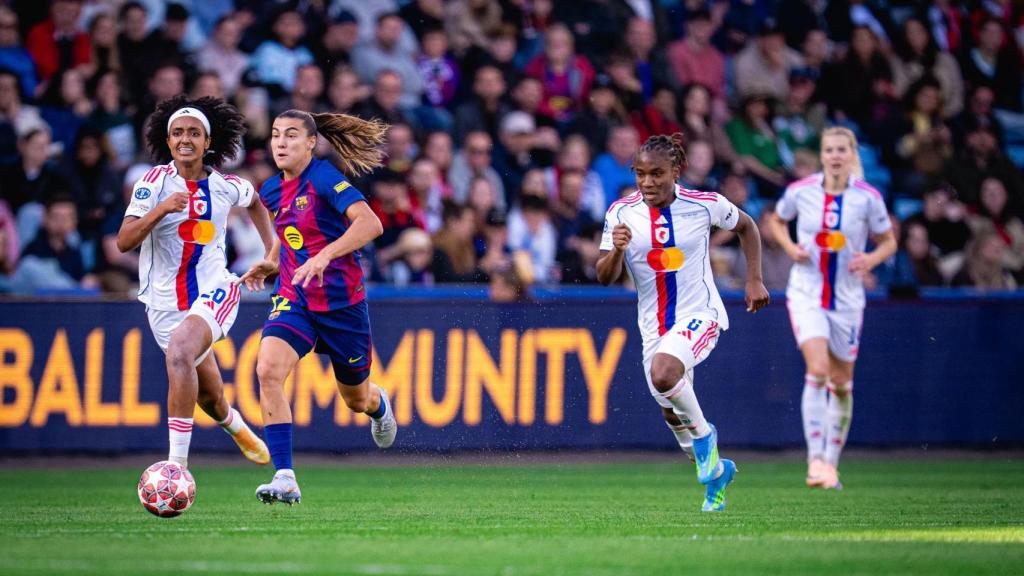 Patri Guijarro conduce el balón, perseguida por dos jugadoras del OL Lyonnes en la final de la Champions League