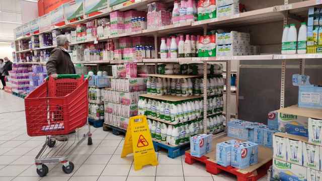 Varias personas compran leche en un supermercado durante el parn del sector lcteo. / EFE