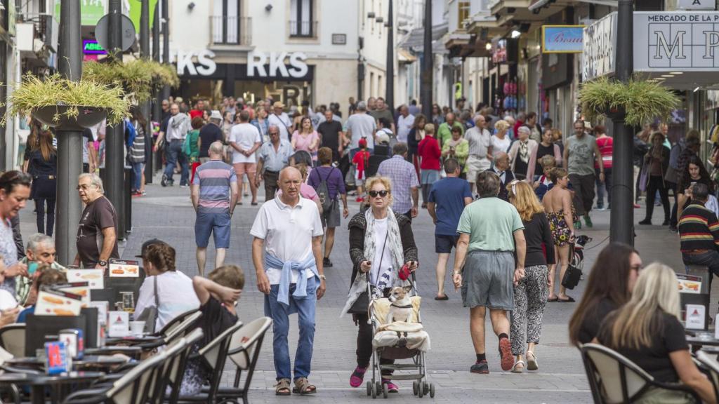 Una calle de Benidorm, próxima al paseo marítimo, llena de turistas paseando y en las terrazas, durante las vacaciones de Semana Santa.