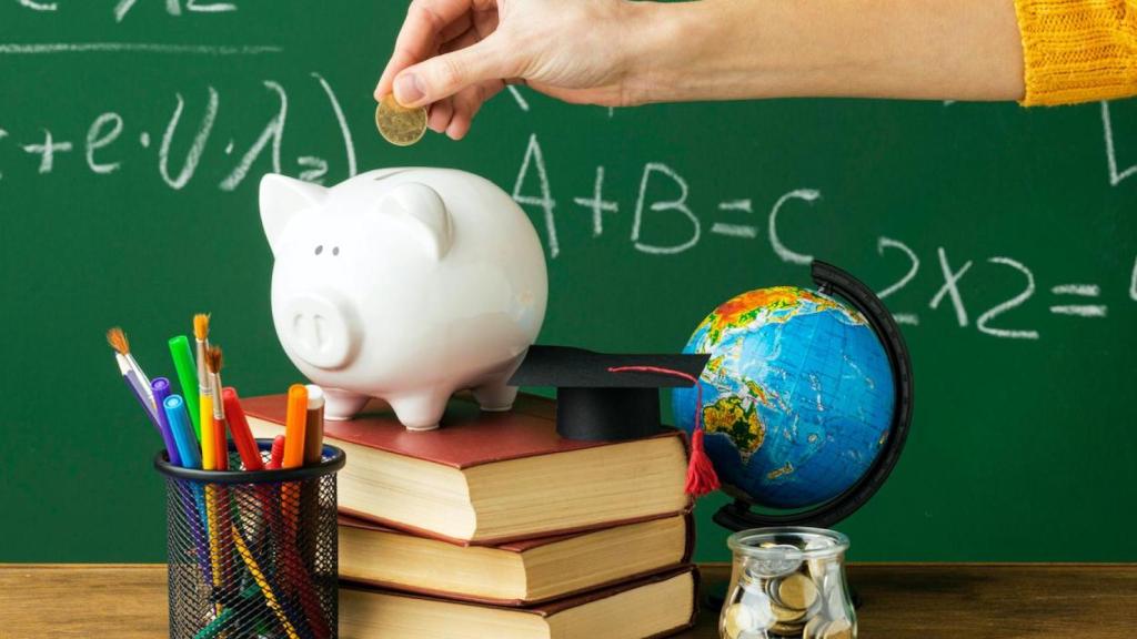 Ahorro en hucha cerdito sobre libros de estudio