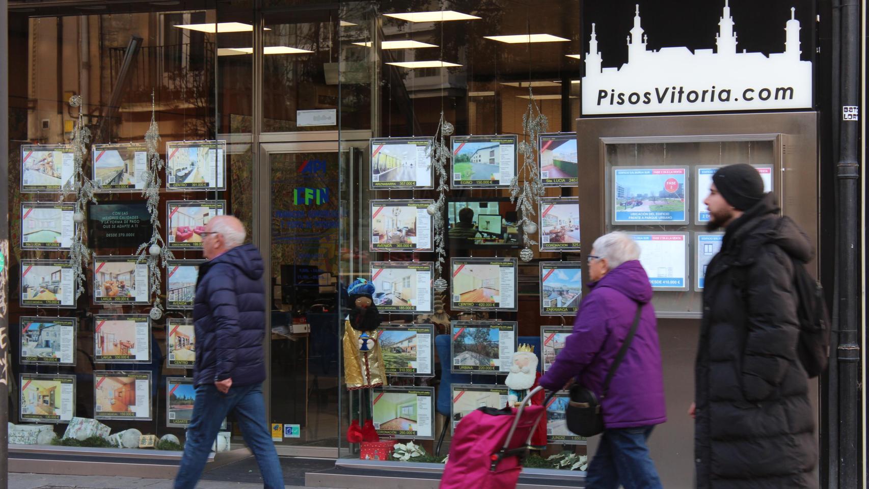 Varias personas caminan frente a una inmobiliaria en Vitoria en una imagen de archivo