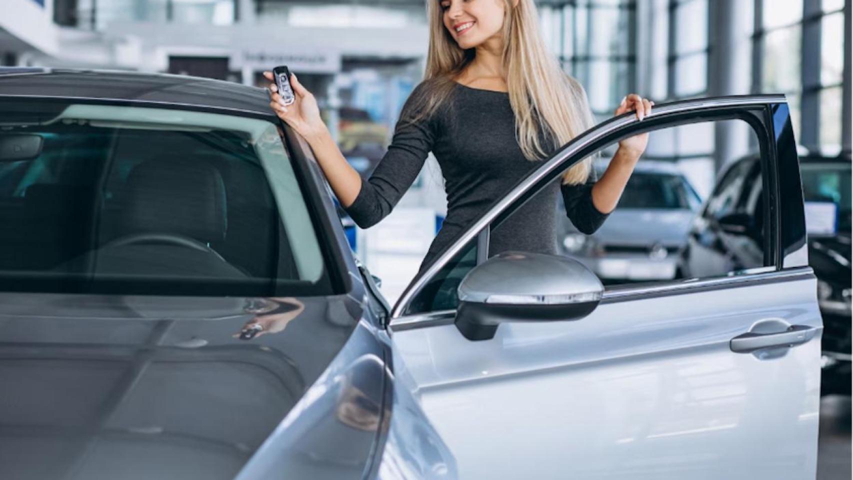 Mujer joven entra en un coche nuevo
