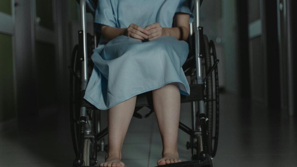 Imagen de una enferma con silla de ruedas en un hospital.
