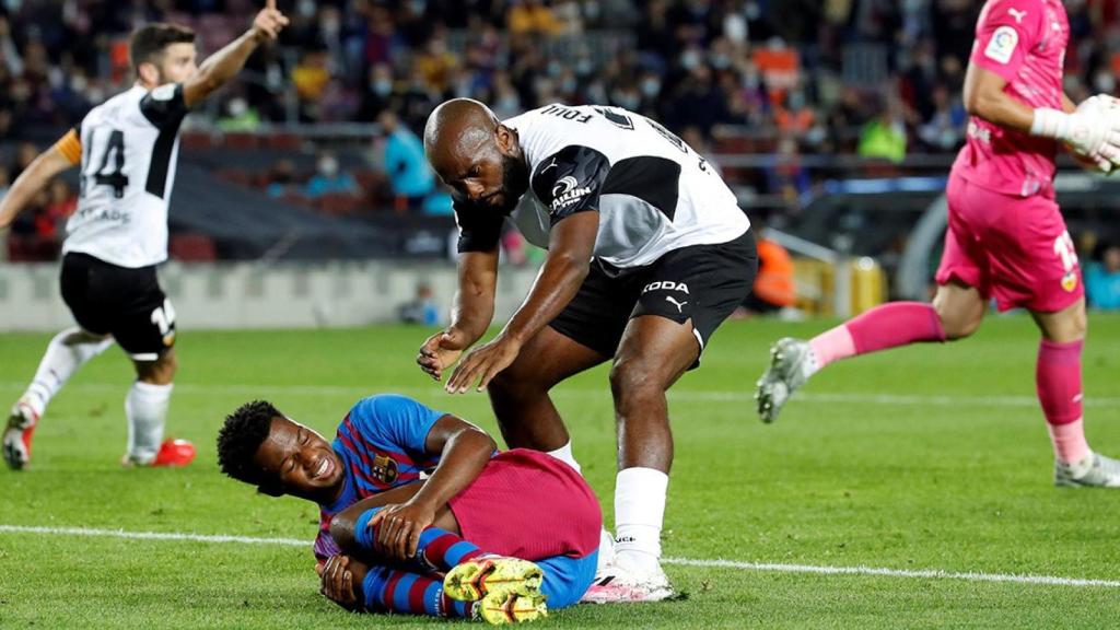 Ansu Fati, en el suelo, tras recibir un golpe de de Gayà dentro del área