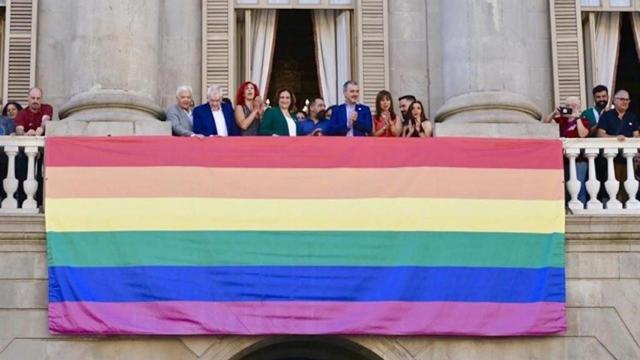 Ada Colau junto a otros concejales en el balcón del Ayuntamiento de Barcelona con el pendón LGTBI / EP