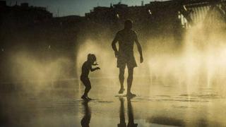 Dos personas se refrescan por las altas temperaturas de la ola de calor / EFE