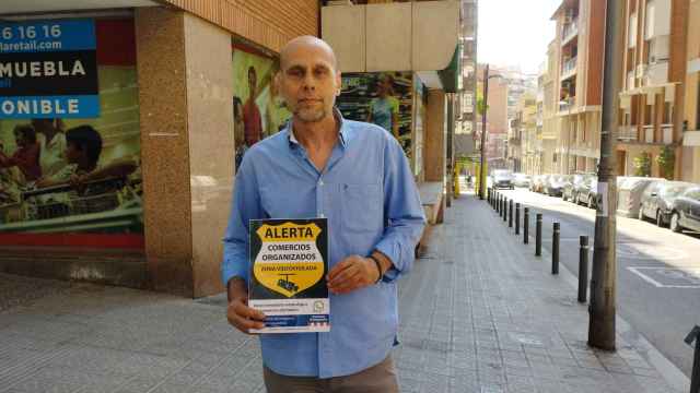 José Carlos Raso, comerciante de Sant Gervasi, muestra uno de los carteles que lucen muchos comercios del barrio / METRÓPOLI