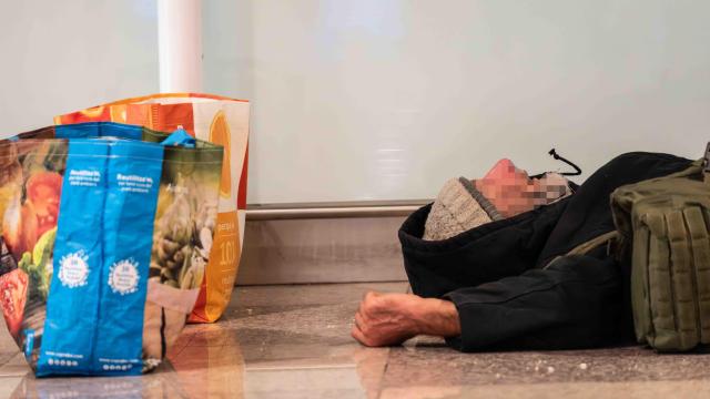 Una persona sin hogar durmiendo en el Aeropuerto de Barcelona