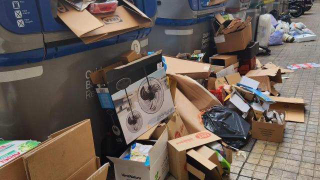 Un contenedor a rebosar de basura en la calle Consell de Cent