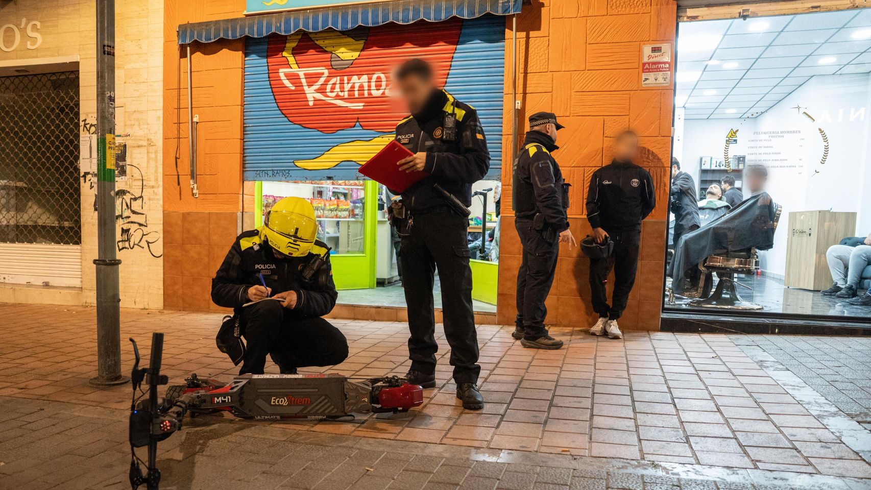 Agentes de la Guardia Urbana de Badalona revisando un patinete