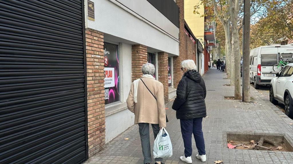 Dues veïnes del barri de Porta mirant la porta de la nova discoteca 'Enigma'