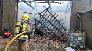 Bomberos apagando el fuego en una nave de Sabadell