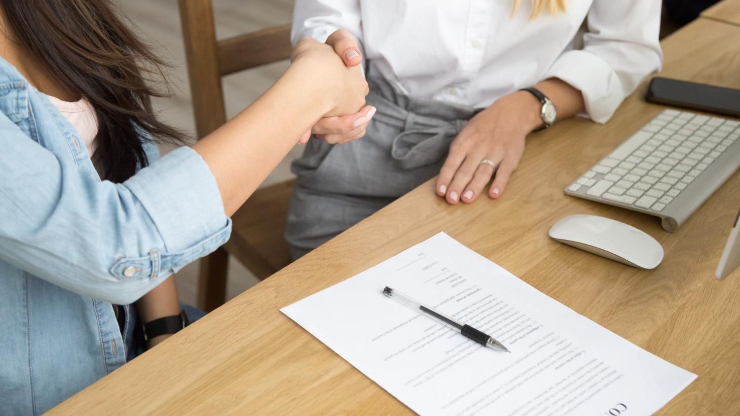 Apretón de manos tras firmar un contrato laboral