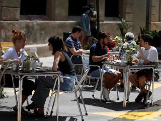 Jóvenes disfrutan de un vermú en una terraza del barrio del Poble Sec, en Barcelona. Efeagro/Toni Albir